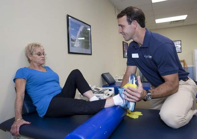 Mike Manzo, a physical therapist who owns Atlantic Physical Therapy Center with his brother Dave, works with client Yvonne Cohn, Brick, in their Howell office. 